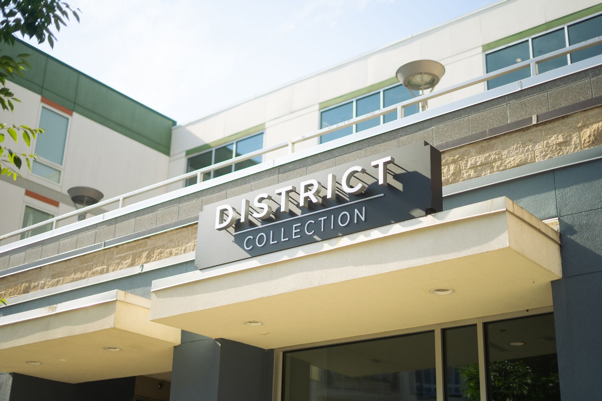 Illuminated District Collection channel-letter sign installed by Design Element